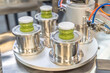 close up on Pesto sauce Industrial process. vacuum sealing machine for canned food. production of Pesto sauce. Vacuum Seamer for Cylindrical Cans of Rotary Type.