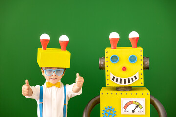 Wall Mural - Happy child with toy robot in class