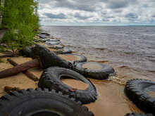 View Of The Sandy Beach By The Baltic Sea. Seashore With Old Car Tires And Concrete, Human Waste, Curonian Spit, 