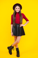 Sticker - Teenager child girl casual clothes posing isolated on yellow background in studio. Kids lifestyle concept. Happy teenager portrait. Smiling girl.