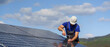 © Halfpoint - Man worker installing solar photovoltaic panels on roof, alternative energy concept.