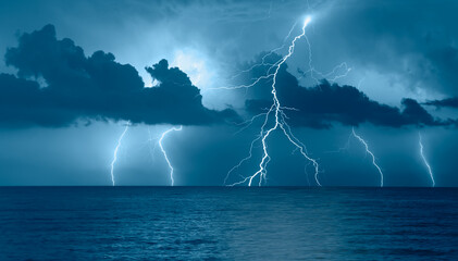 Poster - Beautiful landscape with lightning over the calm sea at sunset 