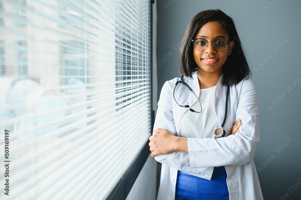 Smiling young adult indian female doctor wear white coat in medical ...
