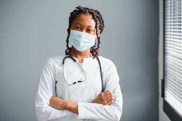 Wall Mural - African female doctor in protective facial mask