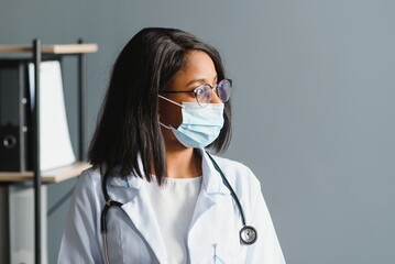 Wall Mural - African female doctor in protective facial mask