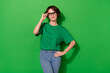 © deagreez - Photo of charming smart woman wear casual t-shirt arm eyeglasses smiling isolated green color background