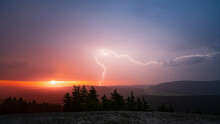 Lightning Strike During A Blazing Sunrise In The Black Forest