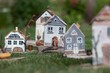 Old wooden houses model over green grass