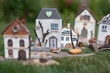 Old wooden houses model over green grass