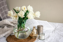 Home Composition With A Bouquet Of Tulips In A Glass Vase And Candles.