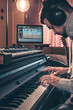 © puhimec - A male musician plays the musical keys in headphones.