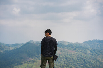 solo backpacker man happy and joyful after success climb the mountain