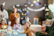 © pressmaster - Close-up of father carrying cake with burned candles to congratulate his son with birthday