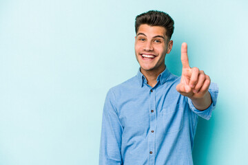 Young caucasian man isolated on blue background showing number one with finger.