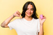Young hispanic woman holding a keys car isolated on pink background feels proud and self confident, example to follow.