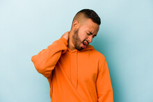 Young Hispanic Man Isolated On Blue Background Suffering Neck Pain Due To Sedentary Lifestyle.
