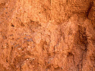 Texture of red clay. Natural natural patterns. Dry red background closeup.