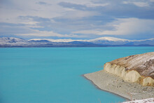 Aqua Lake With Snow Capped Mountains, Lake Pukaki At Mt Cook In The South Island Of New Zealand