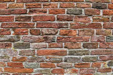 Wall of ancient red and grey bricks. Detail of the medieval brick wall of an old church in the north of the Netherlands
