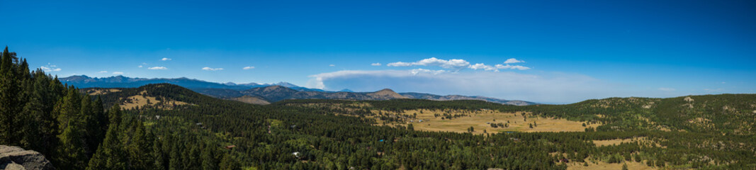 Wall Mural - panorama of the mountains with distant smoke cloud