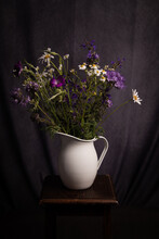 Painterly Studio Still Life Of White And Purple Wild Flowers In Vase On Stool