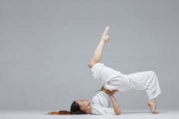 Beautiful young modern dancer or fitness dancer on a white isolated background