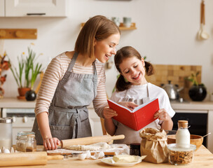 Wall Mural - Positive family loving mother and daughter cooking together