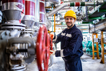 Wall Mural - Oil and gas worker in refinery standing by gas pipeline and closing valves.