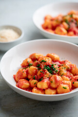 Sticker - Gnocchi with tomato sauce and parmigiano on a plate