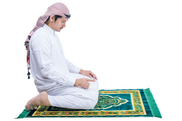 Wall Mural - Muslim man with keffiyeh with agal in praying position (salat) on the prayer rug