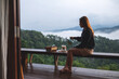 © Farknot Architect - A young woman making drip coffee with a beautiful mountain and nature view in background