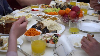 Wall Mural - Islamic holiday Eid al Adha. Happy Muslim family having lunch together, Halal meals