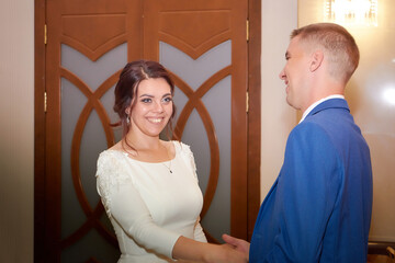 The bride and groom during beautiful marriage ceremony at the registry office in Russia. The concept of love and family