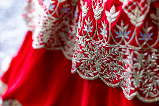 Indian Punjabi bride's red wedding outfit fabric and textile close up