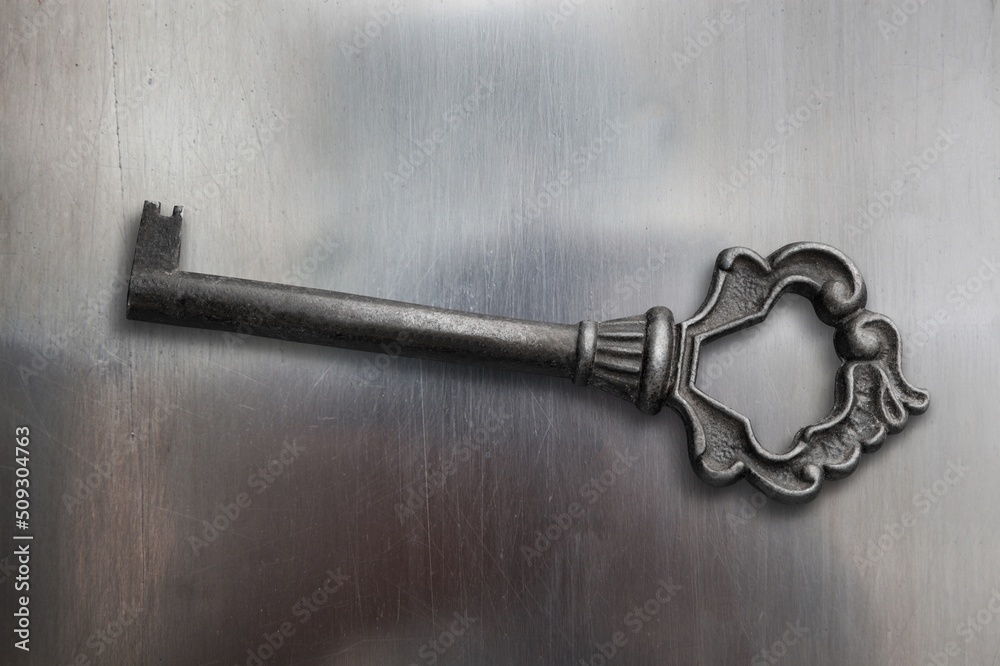 Antique bronze key on metal texture Stock Photo | Adobe Stock