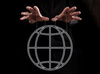 global manipulation. hands holding earth by strings. government, press trying to exert influence on 
