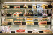 © nazarovsergey - Glass showcase of pastry shop with various cakes and pastries