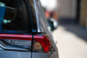 Wall Mural - detail on the rear light of a car, close up of red taillight