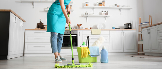 Sticker - Young woman mopping floor in kitchen