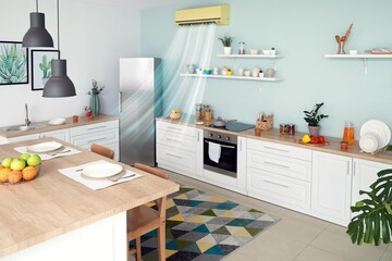 Blowing air conditioner mounted on wall in kitchen