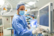 © Graphicroyalty - Anesthetist Working In Operating Theatre Wearing Protecive Gear checking monitors while sedating patient before surgical procedure in hospital