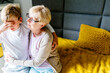© Iryna - Sad cute grandson with his lovely grandmother in his room at home. Happy family relationships, love, caring for an old woman.