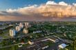 ariel panoramic view of city and skyscrapers with huge storm cloud in the background