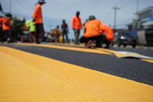 Blurred Image, Paved Road And Yellow Traffic Markings