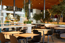 Background Image Of Empty Food Court Interior With Wooden Tables And Warm Cozy Light Setting, Copy Space