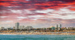 Sunset panoramic view of Santa Monica. City skyline and beach over the water