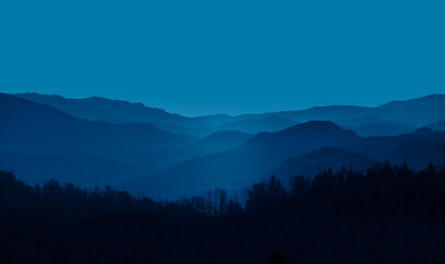 Wall Mural - beautiful landscape with blue misty silhouettes of mountains