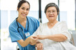 © kanpisut - Nurse take care Elderly patient  in hospital ward. Elderly woman sit down at hospital. Senior woman at hospital for a check-up