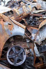 A lot of rusty burnt cars in Irpen, after being shot by the Russian military. Russia's war against Ukraine. Cemetery of destroyed cars of civilians who tried to evacuate from the war zone.