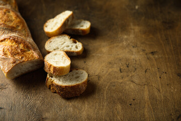 Poster - Traditional homemade baguette bread on a wooden table